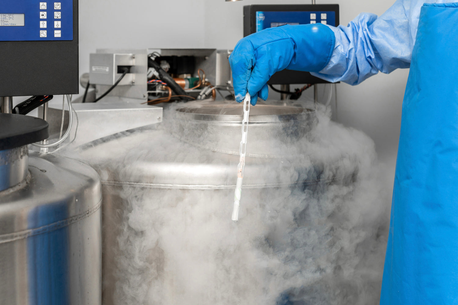 Person in Scilabub cryogenic gloves handling a sample in front of a cryogenic storage tank - safe handling of liquid nitrogen