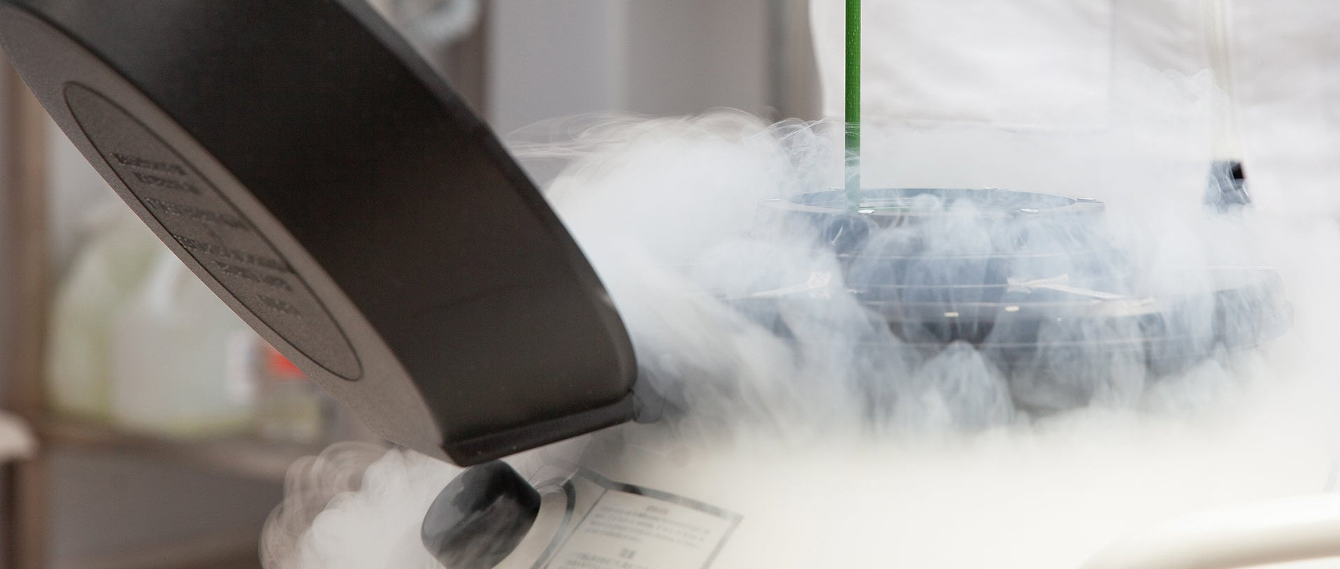 DILVAC - Person in a lab setting with liquid nitrogen and a cryogenic tank.
